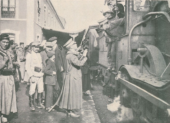 Soldiers beside a locomotive, 1914